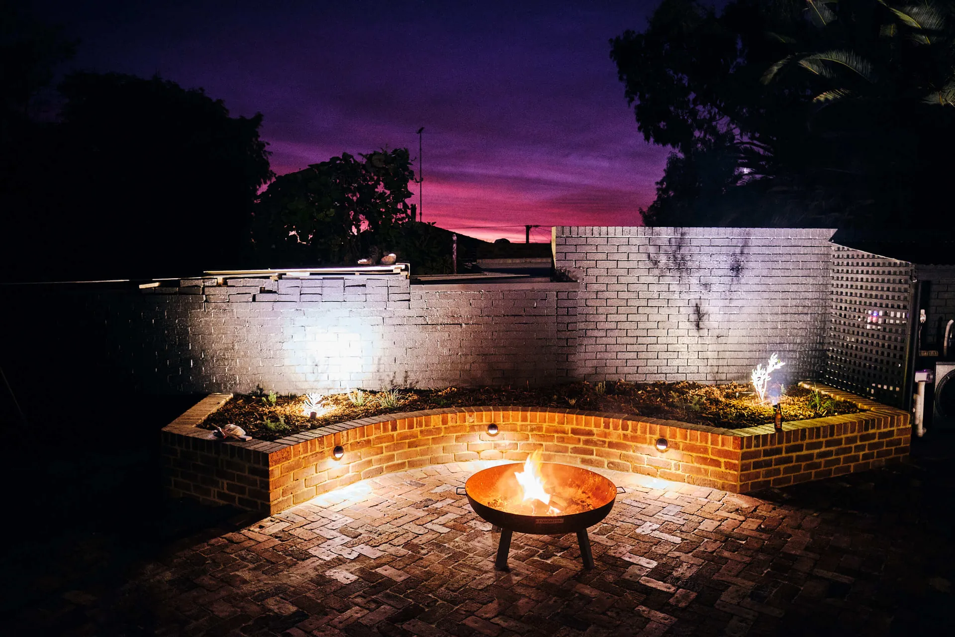 Custom firepit and seating area in the new Beaconsfield Perth backyard makeover for family entertaining.
