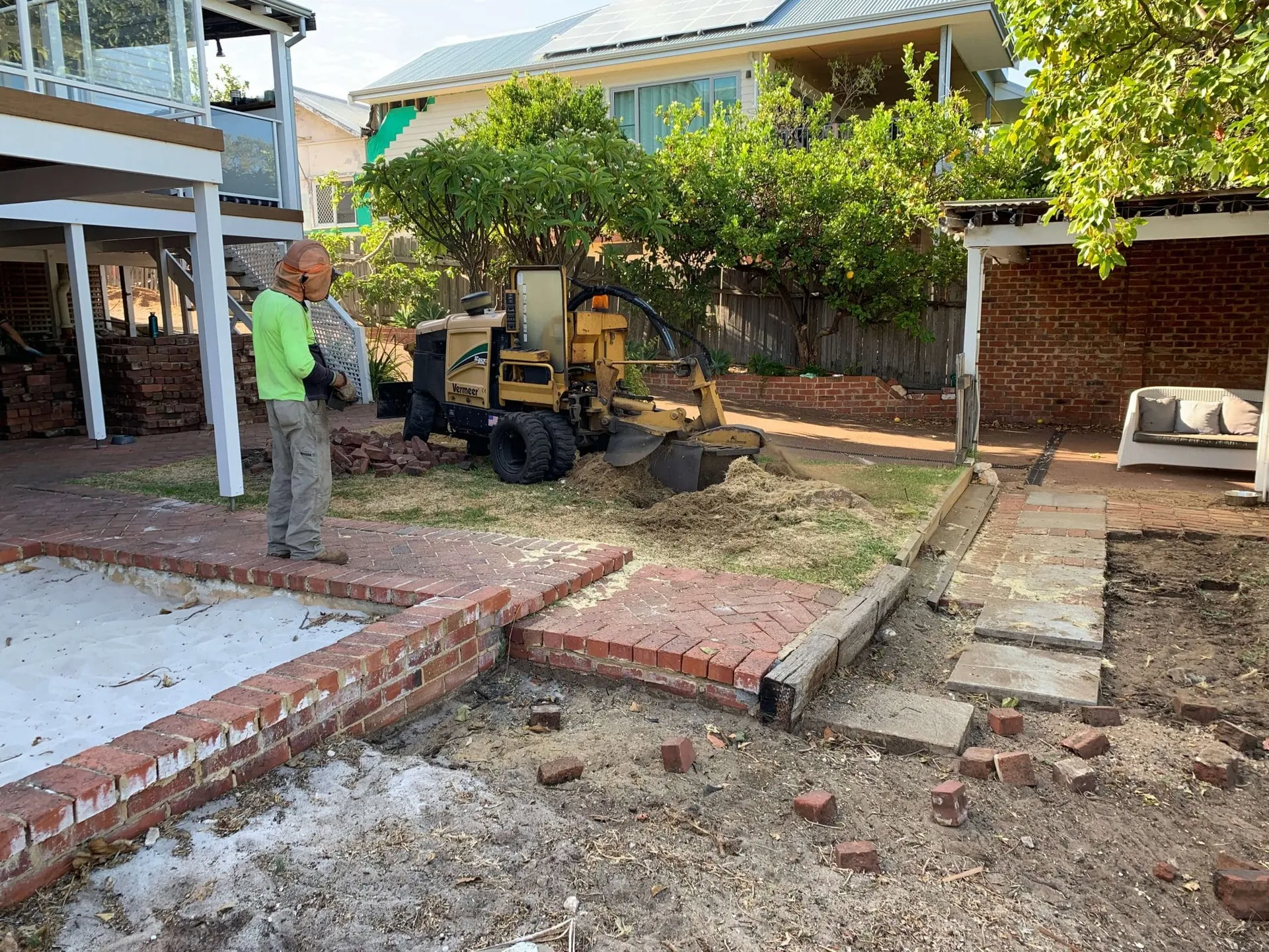 Recycled red brick retaining wall being laid at the Beaconsfield Perth backyard makeover.