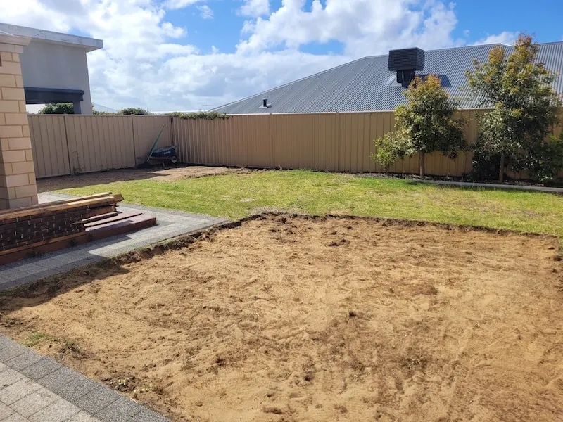 Beeliar backyard before landscaping in Perth, showing tired grass, old deck and plain layout.