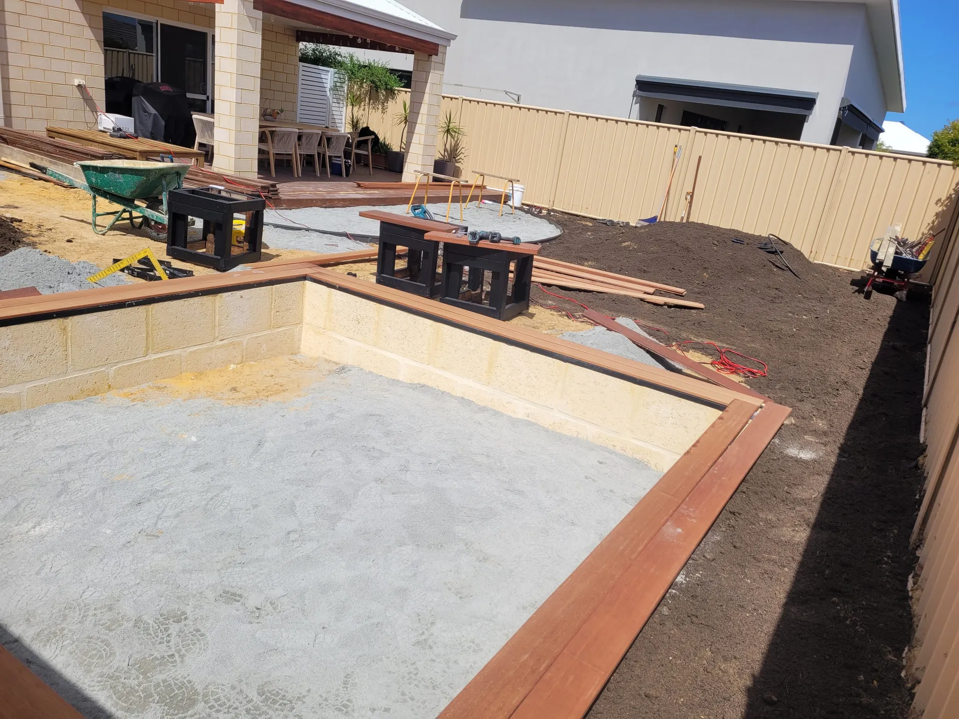 Landscape construction progressing in Beeliar Perth with edging, mulch and feature elements in place.