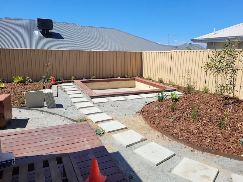Landscape installation underway at the Beeliar Perth backyard makeover with fresh garden beds.