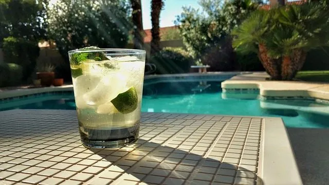 Cocktail beside a Perth swimming pool surrounded by lush poolside plants