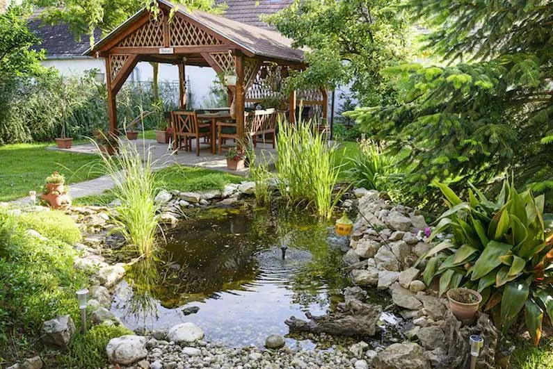Ornamental garden pergola and water feature in a creative landscape design