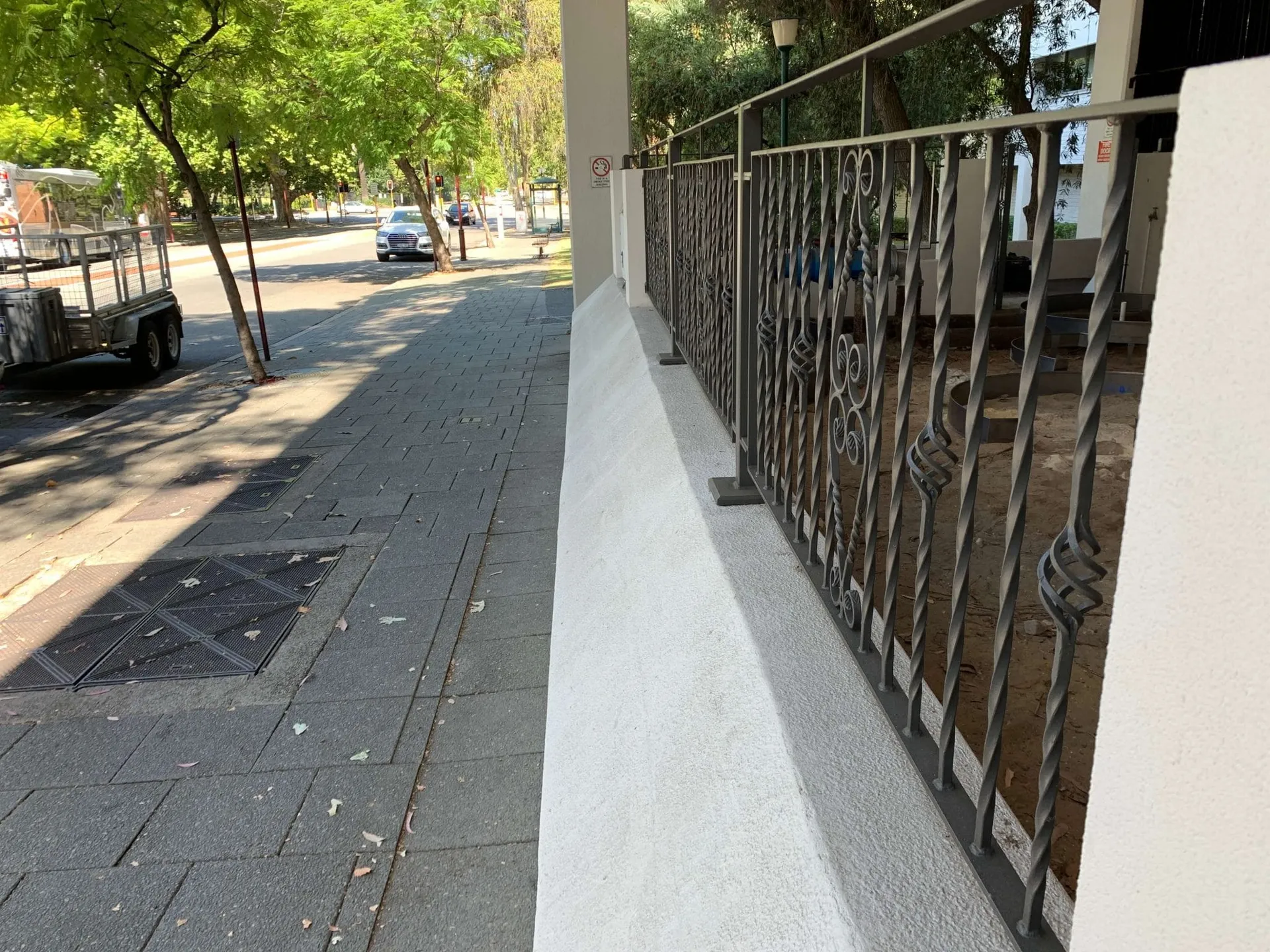 Bare sandy ground at 169 Hay Street Perth before landscaping, exterior view of the building entrance.