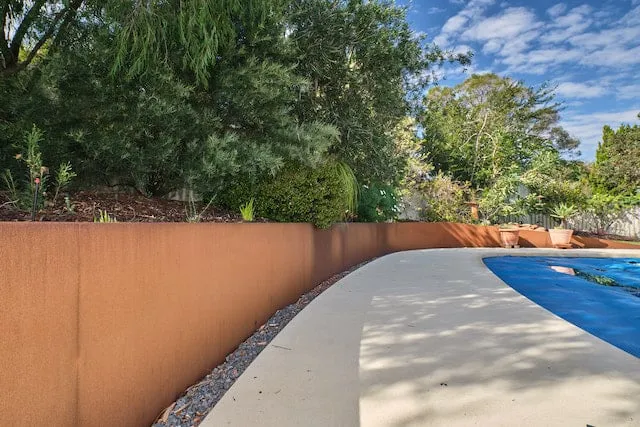 Renovated pool area in Leeming Perth with corten steel edging, gravel drainage and lush plants.
