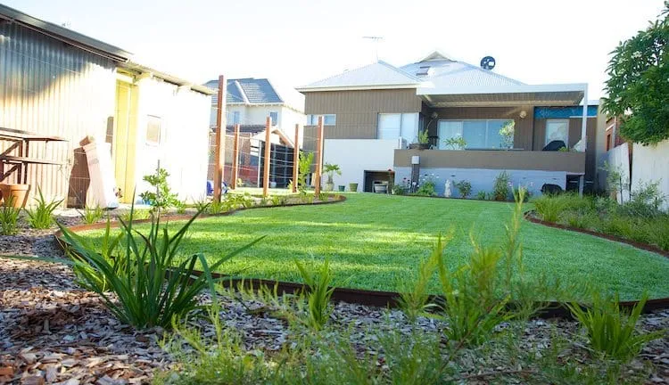 Beautifully landscaped Perth backyard with lawn, paving and garden beds