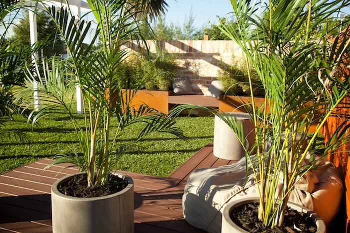 Outdoor bench set against a backdrop of lush planting at the Perth Garden Show display.
