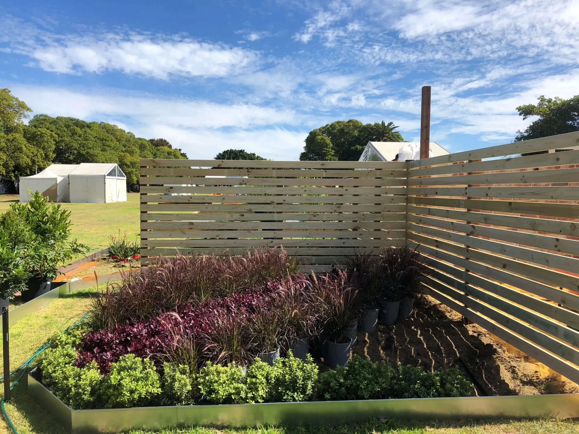 Corner detail of the finished Perth Garden Show display with mixed planting and natural materials.