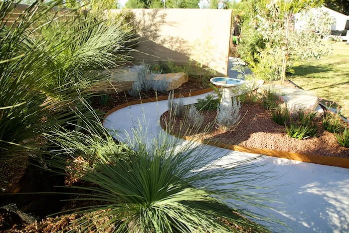 Native-themed show garden by Perth Landscaping Experts featuring grass trees and Toodyay stones.