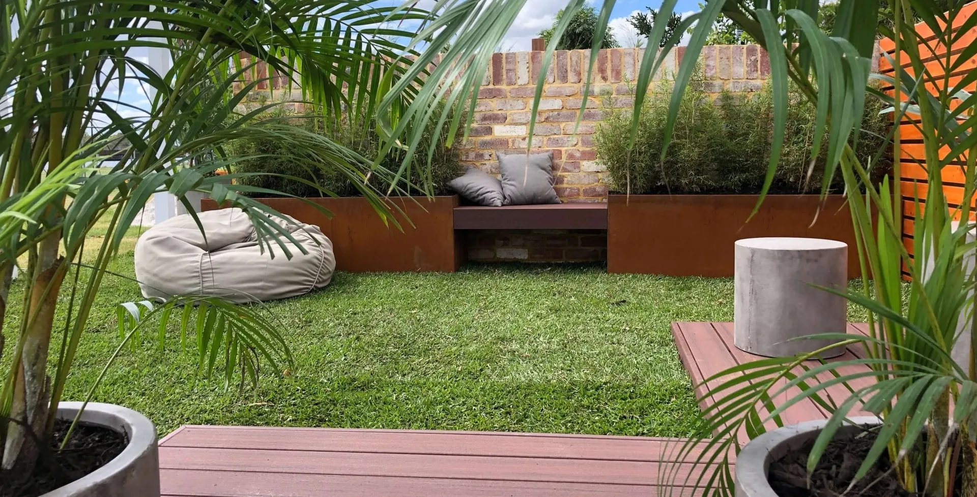 Timber garden bench and lush planting at the Perth Garden Show display by Perth Landscaping Experts.