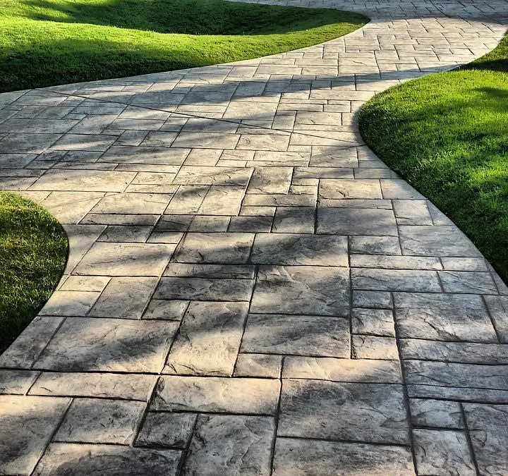 Landscaped garden pathway blending hardscaping pavers with softscaping plants