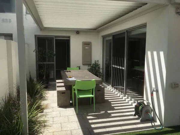 Outdoor table area in the South Perth courtyard before the landscape redesign and planting.